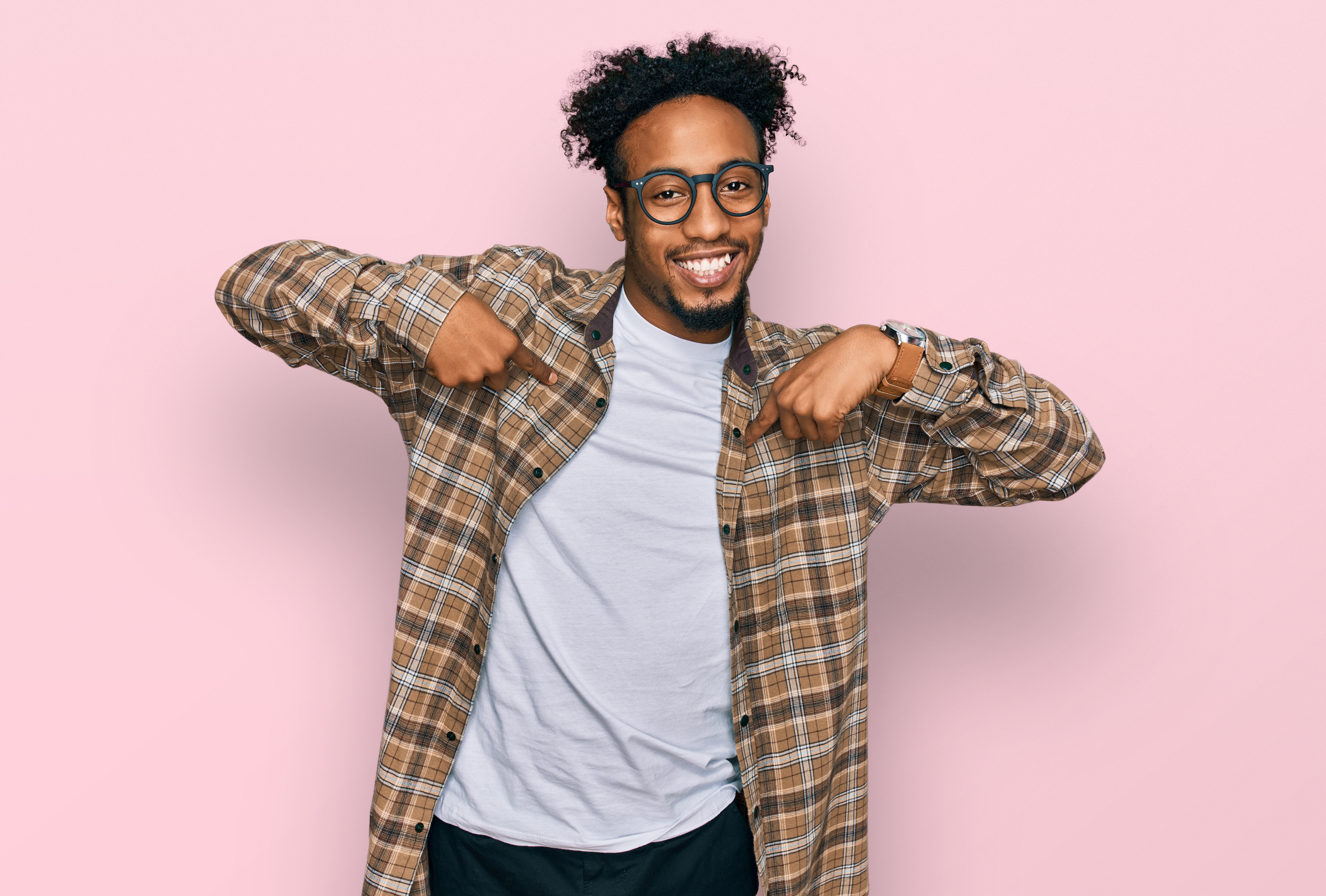 Happy Black man smiling confidently in a studio portrait.